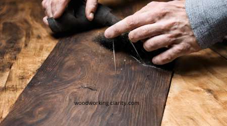 Rubbing dark stained wood with steel wool